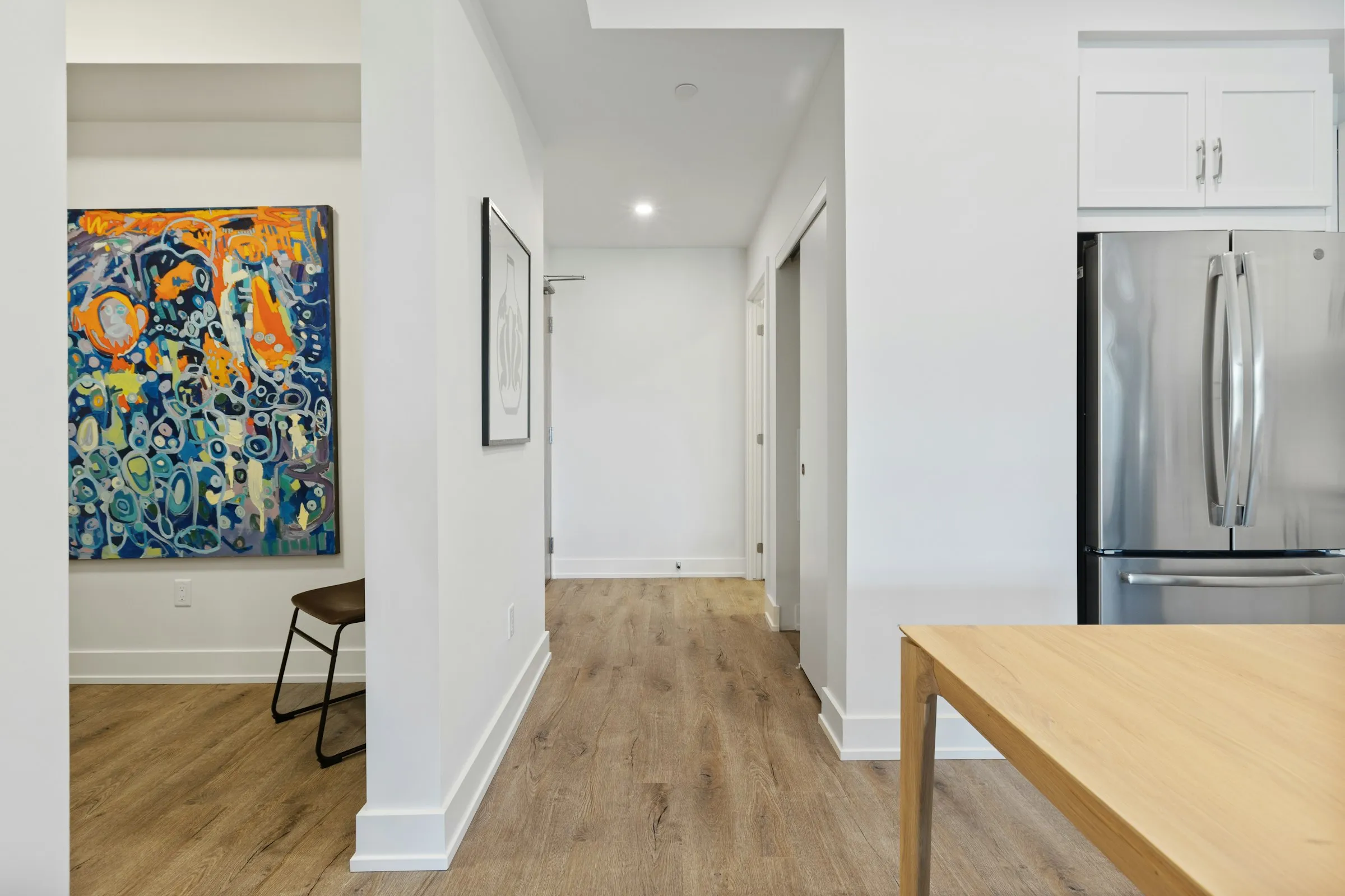 A narrow wooden console table against a white wall