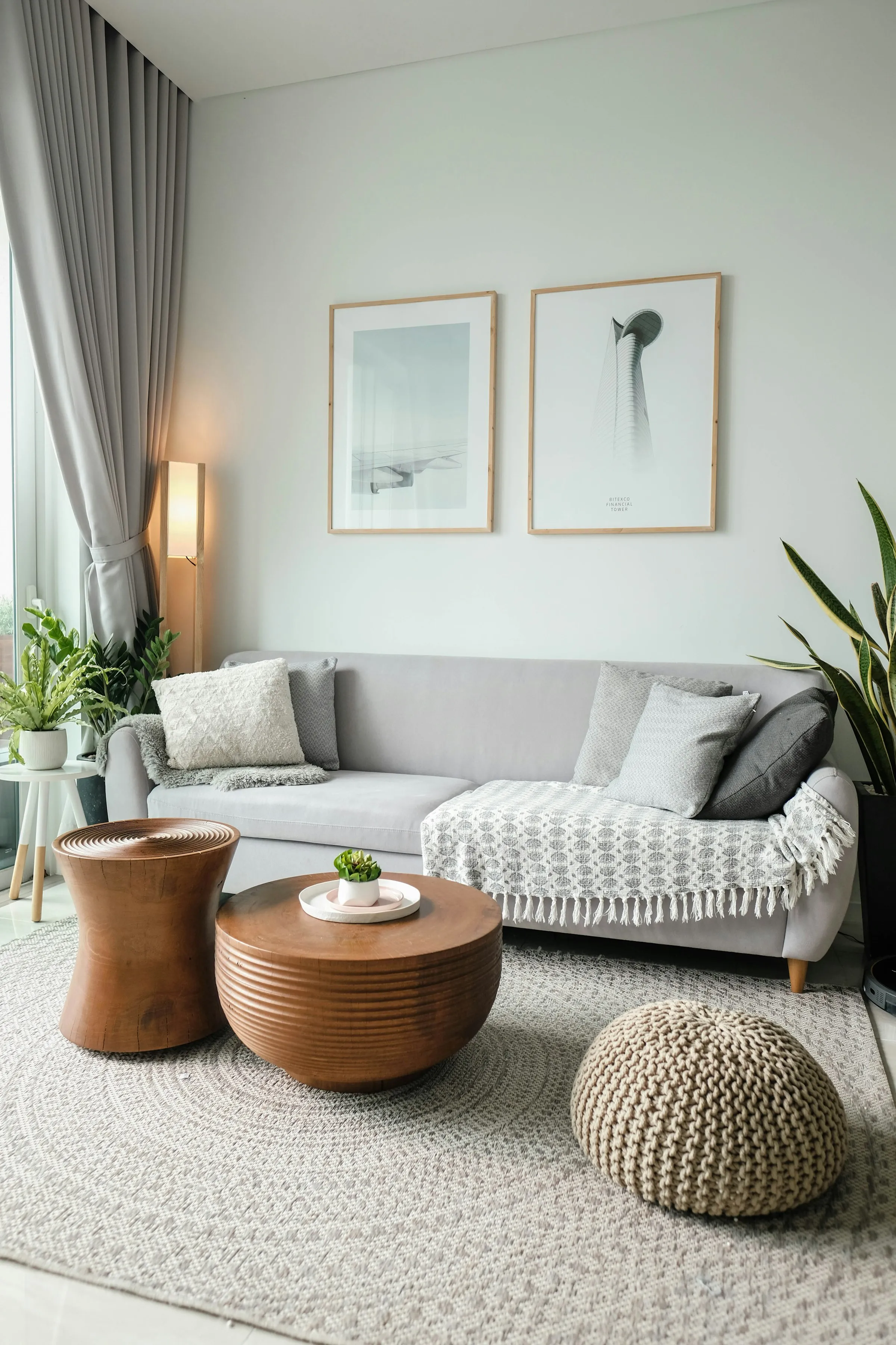 A bright living room with a low sofa beside a large window