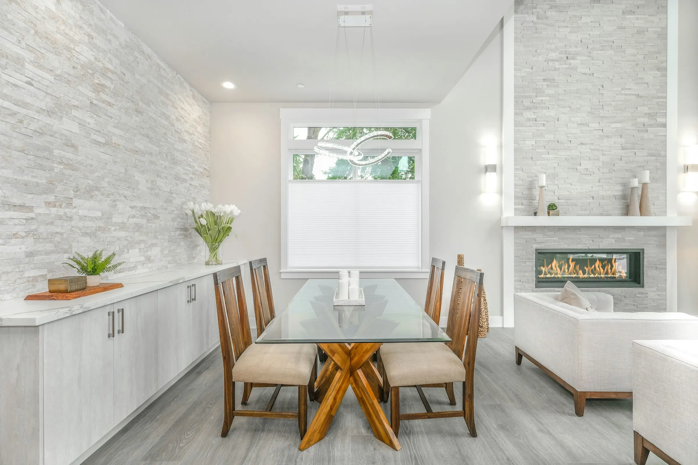 A wooden dining table with matching chairs in a bright room