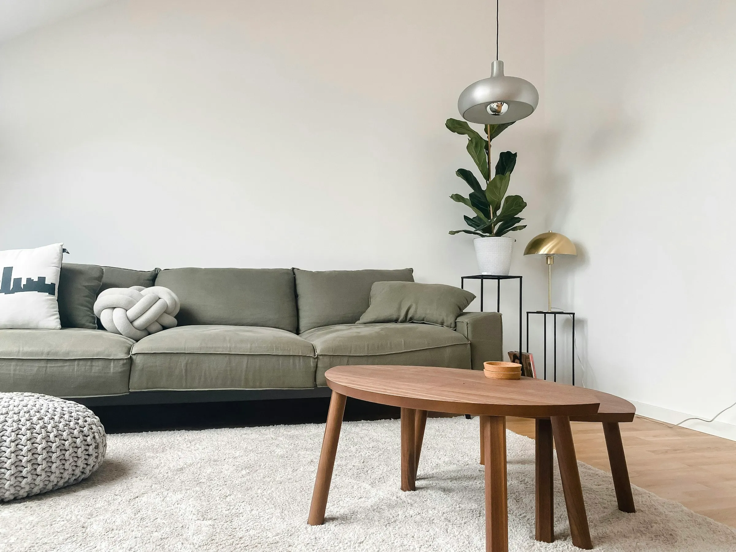 A gray two-seat sofa beside a wooden coffee table